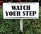 Watch your step sign with stake. 3.5 x 9 inch PVC