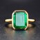 RIZILIA Solitaire Engagement Ring with Emerald Cut Gemstones CZ Simulated Green Emerald Size 6 in 18K Yellow Gold Plated Simple Modern Elegance