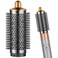 فرشاة PUREGUST الدائرية الملحقة بجهاز Dyson Air wrap، وفرشاة تكثيف الشعر الدائرية البيضاوية لجهاز Dyson Air wrap، وملحقات ذهبية اللون.