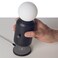 Wireless lamp and charger with modern design in black, combines lighting and device charging for home or office spaces, suitable for contemporary d&eacute;cor