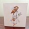 Lady holding her hat on a windy day note card